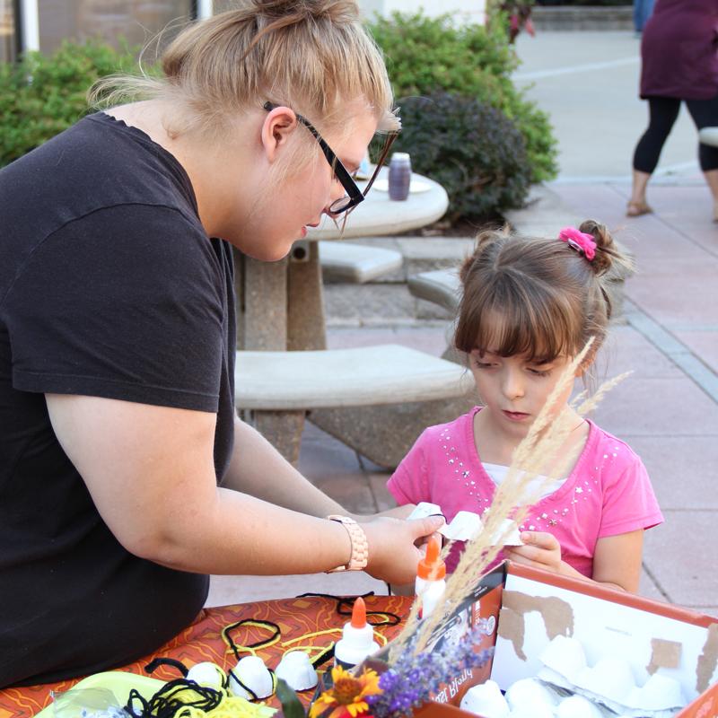 JWCC student making a craft with a young child
