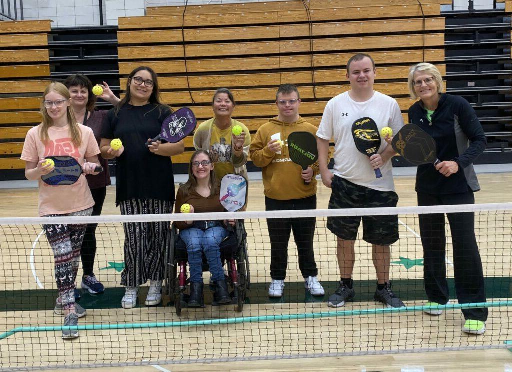 College for Life students posing with pickleball coach